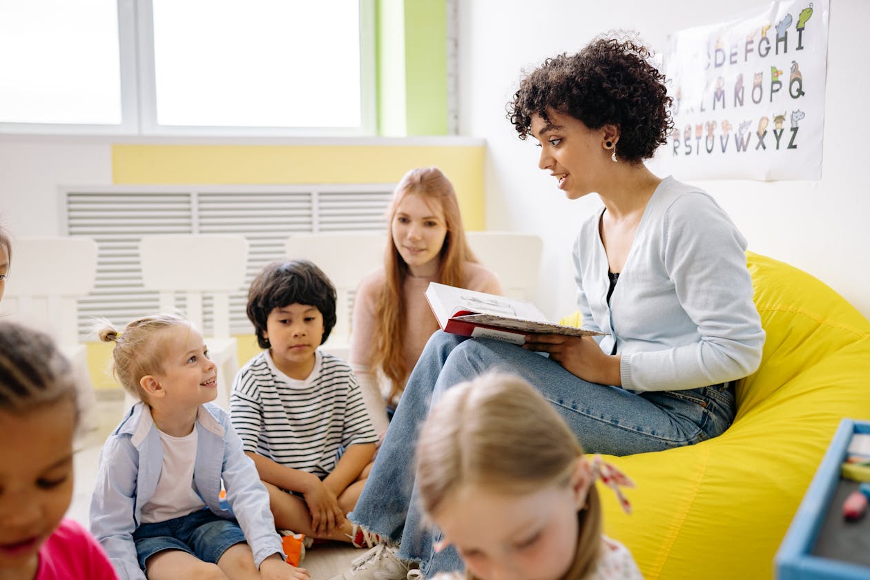 Teacher reading to preschool children in a colorful classroom